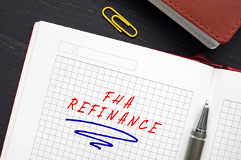 A notebook with the word "refinance" and "FHA loan" written on it.